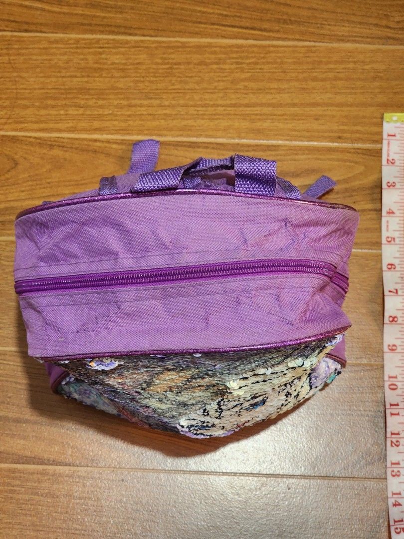 Disney Frozen Elsa & Anna Sequin Backpack Purple (Category: Babies & Kids Fashion) located in Meycauayan. Submitted by MP_Shop (Listing ID 1440491817, Image 2). Description: - Features beloved characters Elsa and Anna - Eye-catching reversible sequins that change color - Adjustable straps for a comfortable fit - Zipper closure for the main compartment - Ideal for school, travel, or everyday adventures - Approximately 10 inches tall.