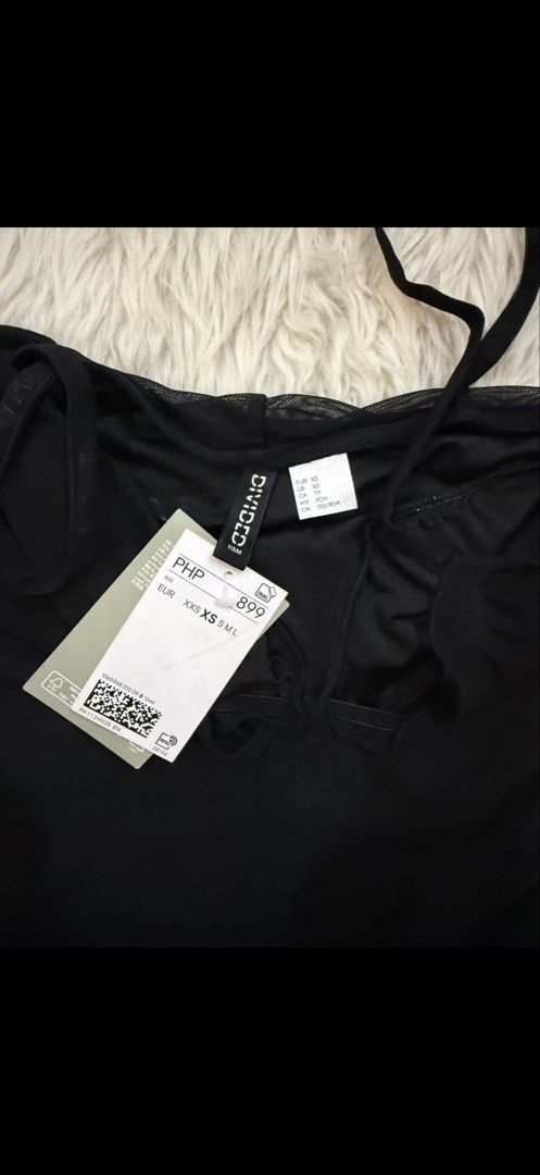 Divided H&M Black Ruched Mini Dress (Category: Dresses) located in Cebu City. Submitted by hazelcris (Listing ID 1440408665, Image 3). Description: - Divided black ruched mini dress - Adjustable spaghetti straps - Tie detail at the bust - Flattering ruched silhouette - Ideal for nights out or parties - Size XXS.
