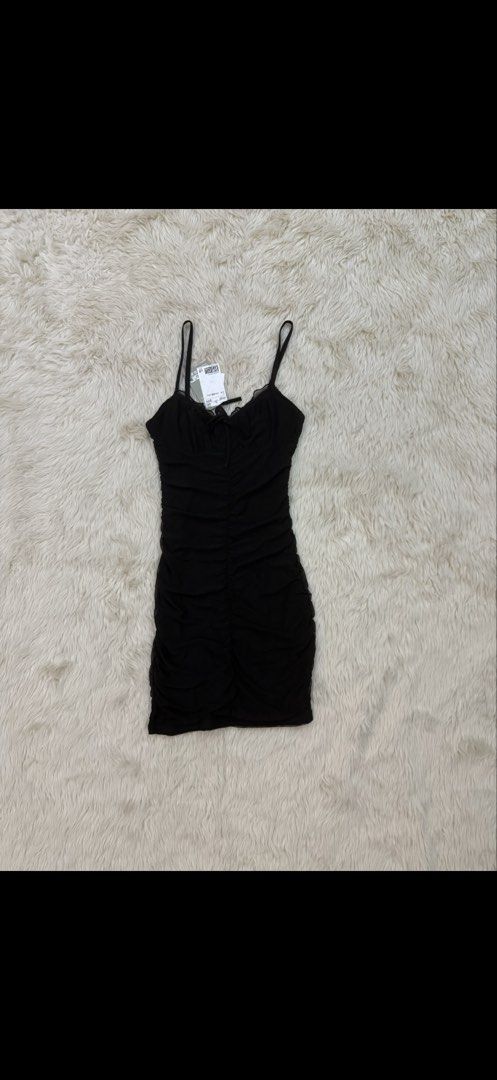 Divided H&M Black Ruched Mini Dress (Category: Dresses) located in Cebu City. Submitted by hazelcris (Listing ID 1440408665, Image 2). Description: - Divided black ruched mini dress - Adjustable spaghetti straps - Tie detail at the bust - Flattering ruched silhouette - Ideal for nights out or parties - Size XXS.