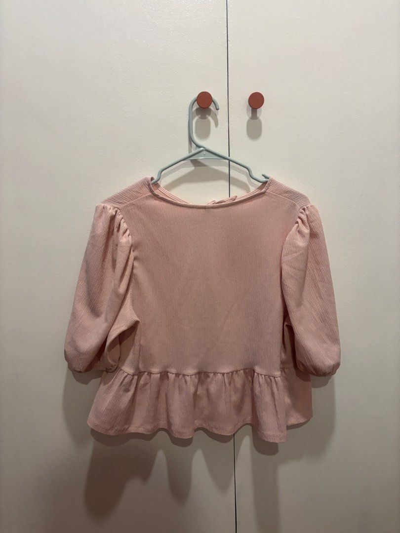 DIVIDED Pink Peplum Tie-Back Top Size L (Category: Sleeveless) located in Muntinlupa City. Submitted by beacq (Listing ID 1440471599, Image 3). Description: - Cute pink peplum top from DIVIDED - Features puff sleeves and a ruffled hem - Stylish tie-back detail at the neck - Versatile for pairing with jeans or skirts - Comfortable and chic for everyday wear.