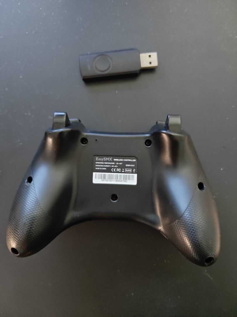 EasySMX Wireless Controller (Category: Controllers) located in Singapore. Submitted by cutedog1 (Listing ID 1440475116, Image 2). Description: - Wireless game controller - Includes USB dongle - Color: Black - Compatible with PC - LB button partially stuck but still functional.