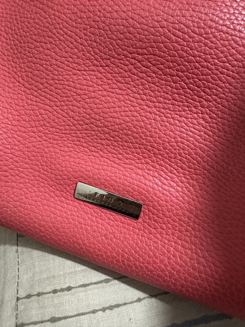 Fino Leatherware Bag (Category: Tote Bags) located in Manila. Submitted by prelovedbymycam (Listing ID 1440429035, Image 3). Description: - Brand: Fino Leatherware - Color: Pink - Material: Pebbled Leather - Style: Structured Tote Bag - Features: Two top handles, two front flap pockets, main compartment, interior zip pocket - Additional: Detachable strap - Ideal for: Everyday use.