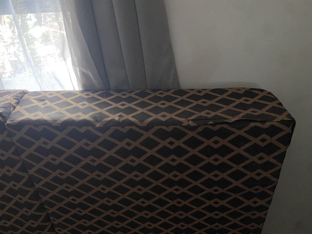Foldable Bed with Geometric Pattern ( Uratex ) (Category: Bed Frames & Mattresses) located in Bulacan. Submitted by wona20 (Listing ID 1440546982, Image 2). Description: Foldable bed with a geometric pattern. It has a headrest section. The bed is folded in the image. The color scheme is a combination of brown and black..