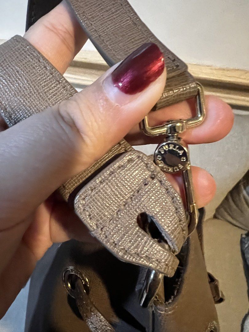 Furla Stacy Medium Drawstring Bucket Bag Leather Taupe (Category: Luxury Bags & Wallets) located in Makati City. Submitted by domingokaye (Listing ID 1440553642, Image 3). Description: - Furla Stacy medium bucket bag - Taupe textured leather - Drawstring closure - Adjustable shoulder strap with gold hardware - Interior with patterned lining - Ideal for everyday use.