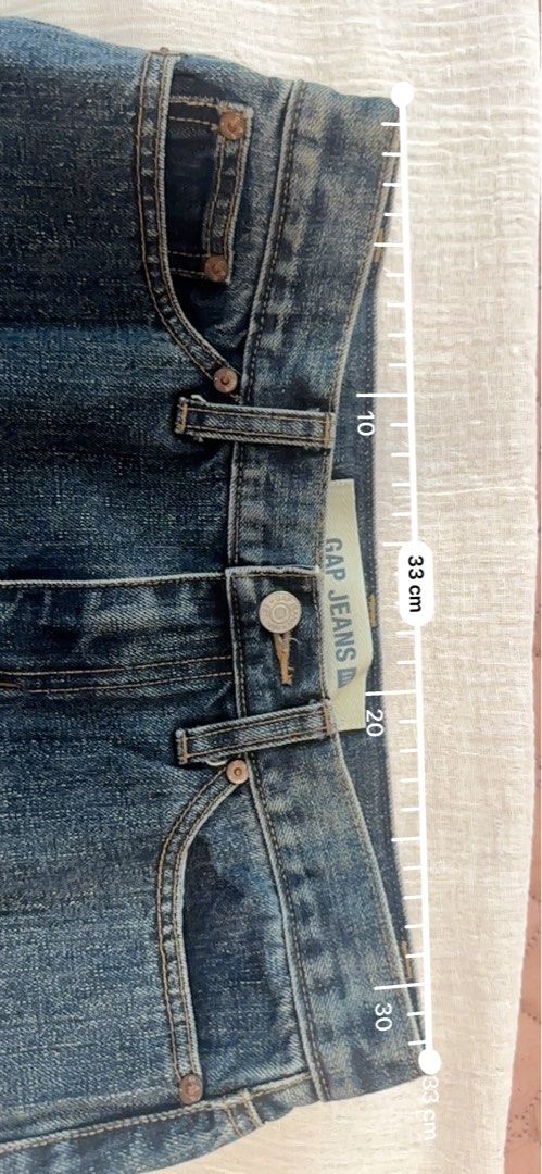 GAP Jeans Denim Midi Skirt with Front Slit (Category: Skirts) located in Manila. Submitted by lev92139 (Listing ID 1440406424, Image 3). Description: - Classic blue denim midi skirt from GAP Jeans - Features a front slit for easy movement - Length: 64cm - Hips: 44cm, size 2 - Waistband: 33cm - A versatile staple piece for any wardrobe.