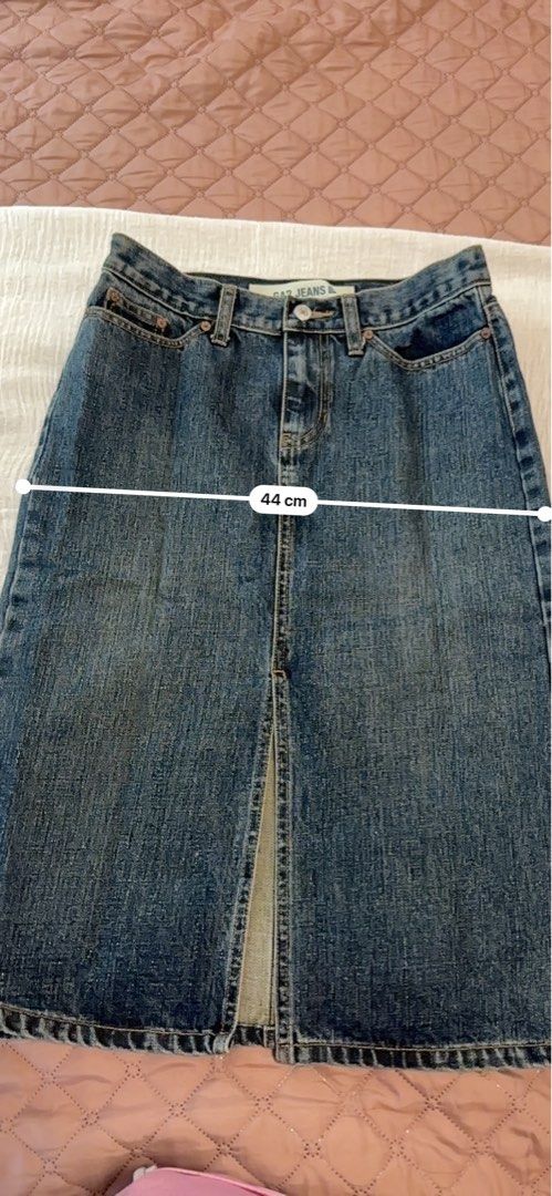 GAP Jeans Denim Midi Skirt with Front Slit (Category: Skirts) located in Manila. Submitted by lev92139 (Listing ID 1440406424, Image 2). Description: - Classic blue denim midi skirt from GAP Jeans - Features a front slit for easy movement - Length: 64cm - Hips: 44cm, size 2 - Waistband: 33cm - A versatile staple piece for any wardrobe.