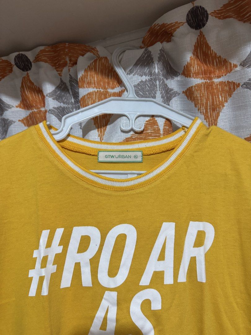 GTW URBAN Yellow #ROAR AS ONE Graphic Tee (Category: Shirts) located in Manila. Submitted by mxbeex (Listing ID 1440518376, Image 2). Description: - Vibrant yellow t-shirt with '#ROAR AS ONE' graphic print - Classic short sleeves featuring stylish white stripes - Comfortable crew neck with white trim detail - Made from a soft and breathable cotton blend - Perfect for everyday casual wear and showing your support.