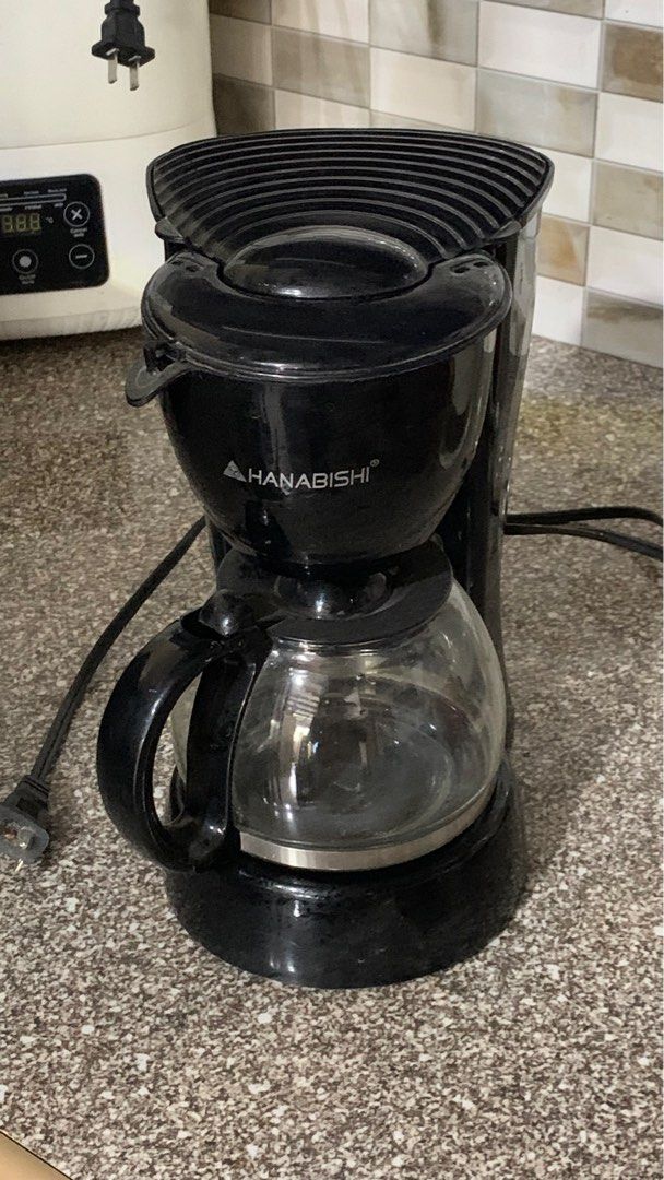 Hanabishi Coffee Maker with Glass Carafe (Category: Coffee Machines & Makers) located in Bulacan. Submitted by abchron (Listing ID 1440576921, Image 1). Description: - Black Hanabishi coffee maker - Includes glass carafe - Brews your favorite coffee - Simple and easy to use - Perfect for daily morning routines - Shows minor scuffs from normal use - Fully functional and works great.
