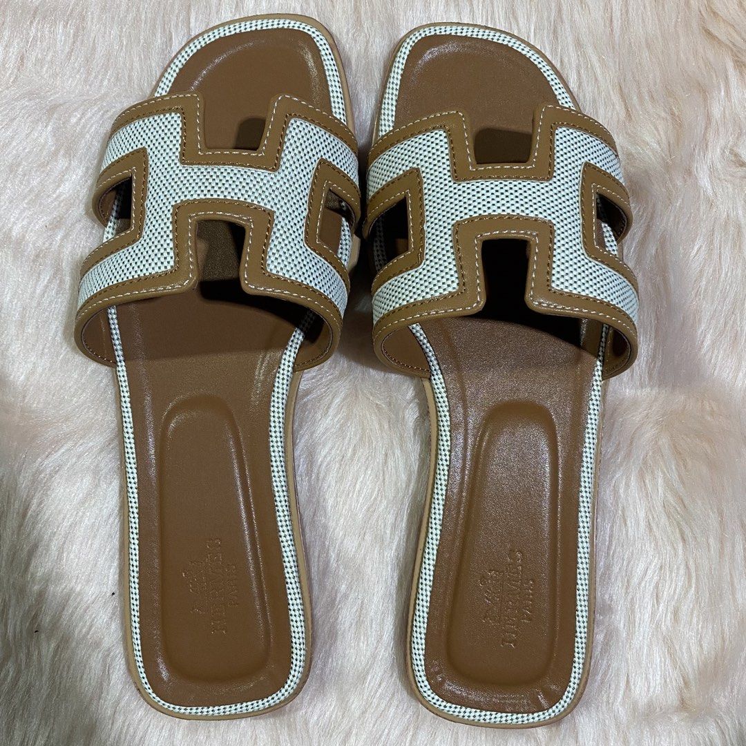 HERMES ORAN SLIPPER (TAN&WHITE) SIZE AVAILABLE (35-41) (Category: Flats & Sandals) located in San Juan City. Submitted by pattycollection113 (Listing ID 1440554331, Image 2). Description: HELLO WELCOME TO OUR SHOP our product is high quality and onhand. INCLUDES: BOX and PAPER BAG. AVAILABLE SIZE 35-41.