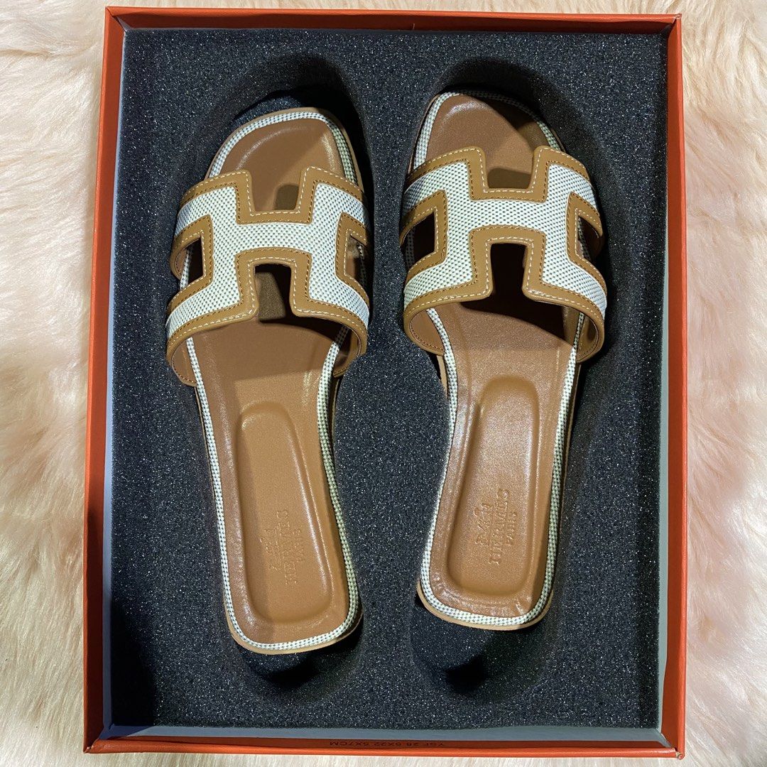 HERMES ORAN SLIPPER (TAN&WHITE) SIZE AVAILABLE (35-41) (Category: Flats & Sandals) located in San Juan City. Submitted by pattycollection113 (Listing ID 1440554331, Image 1). Description: HELLO WELCOME TO OUR SHOP our product is high quality and onhand. INCLUDES: BOX and PAPER BAG. AVAILABLE SIZE 35-41.