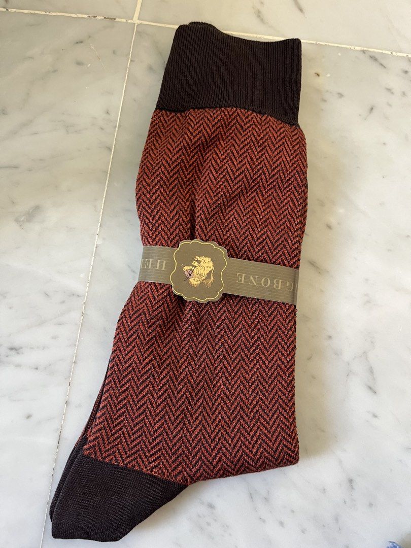 Herringbone Pattern Socks (Category: Socks) located in Singapore. Submitted by gentlephoenix_6faafc (Listing ID 1440397246, Image 1). Description: - Classic herringbone pattern in reddish-brown and black. - Solid dark brown top band and toe. - Features a branded band. - Adds a stylish touch to any outfit..