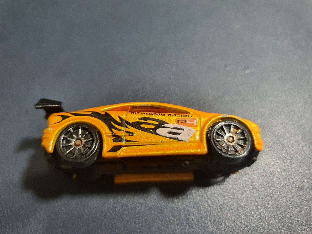 Hot Wheels Asphalt Assault Orange Racing Car (Category: Vehicle & Diecast Models) located in Manila. Submitted by _mugen24 (Listing ID 1440536727, Image 3). Description: - Vibrant orange Hot Wheels car - Features a cool racing design with black accents - Played condition ( Manage your expectations) - Marked '2009 Mattel, Inc. Asphalt Assault' on the bottom - Ideal for both Hot Wheels collectors and playtime fun! Can be delivered by Lalamove, Grab