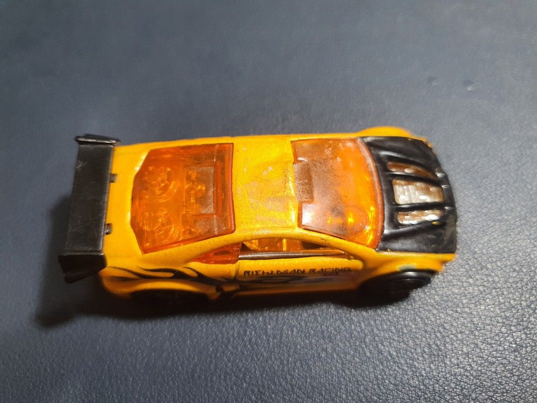 Hot Wheels Asphalt Assault Orange Racing Car (Category: Vehicle & Diecast Models) located in Manila. Submitted by _mugen24 (Listing ID 1440536727, Image 2). Description: - Vibrant orange Hot Wheels car - Features a cool racing design with black accents - Played condition ( Manage your expectations) - Marked '2009 Mattel, Inc. Asphalt Assault' on the bottom - Ideal for both Hot Wheels collectors and playtime fun! Can be delivered by Lalamove, Grab