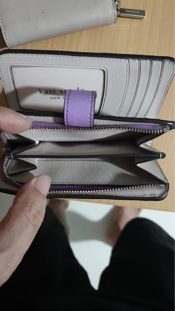 Kate Spade New York Wallets (2 pcs) (Category: Wallets & Card Holders) located in Singapore. Submitted by i_got_character (Listing ID 1440508628, Image 2). Description: - Bundle deal: 2 Kate Spade New York wallets - Wallet 1: Black & beige bifold with zip-around closure - Wallet 2: Lavender bifold with snap closure - Both feature interior card slots and compartments - Ideal for keeping your essentials organized.