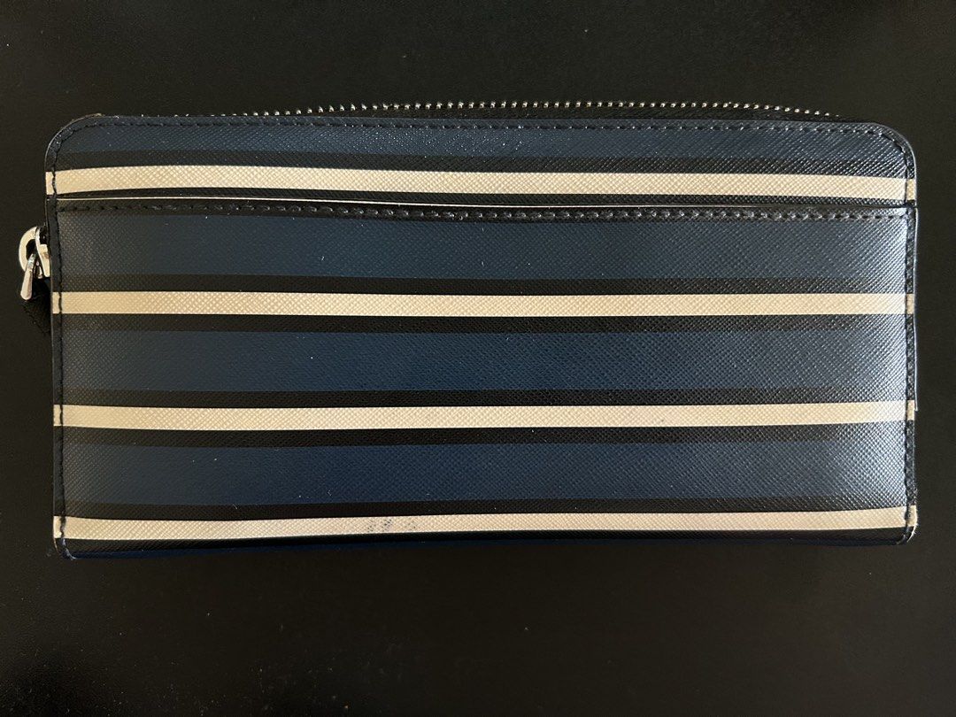Kate Spade Zip Around Wallet (Category: Wallets & Card holders) located in Quezon City. Submitted by bea30 (Listing ID 1440402792, Image 2). Description: - Authentic Kate Spade New York wallet - Secure zip-around closure - Ample card slots and compartments for organization - Minor signs of wear on exterior (as pictured) - Doesn’t come with dustbag or box.