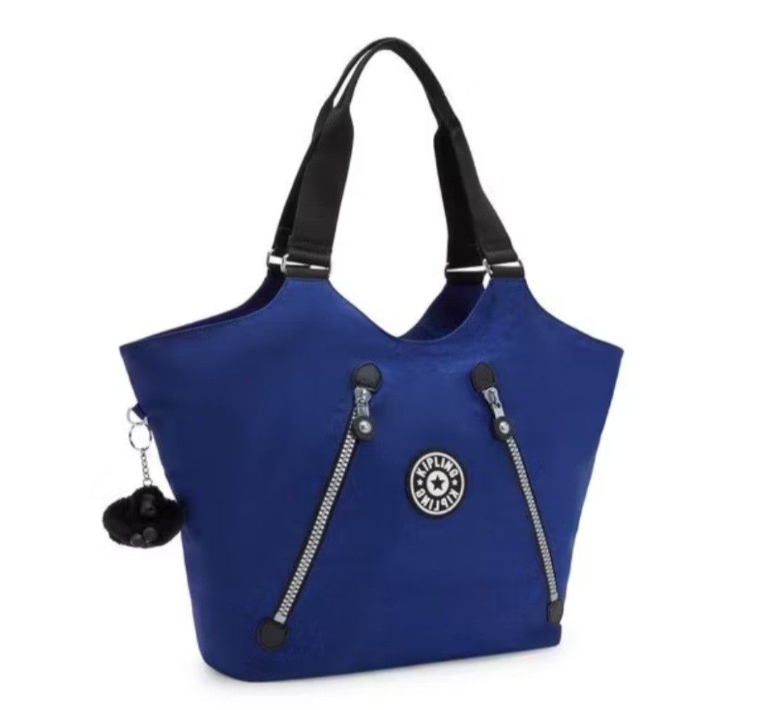 Kipling Cicely Tote Bag Rapid Navy (Category: Tote Bags) located in Davao. Submitted by jilly07 (Listing ID 1440565313, Image 1). Description: - Blue Kipling tote bag - Two front zip pockets - Main zip compartment - Internal smaller pockets for organization - Comes with signature Kipling monkey charm - Ideal for everyday use or travel USED ONLY ONCE TO TRY. In excellent condition, still looks new. NO FLAWS. Comes with tags and original packaging.