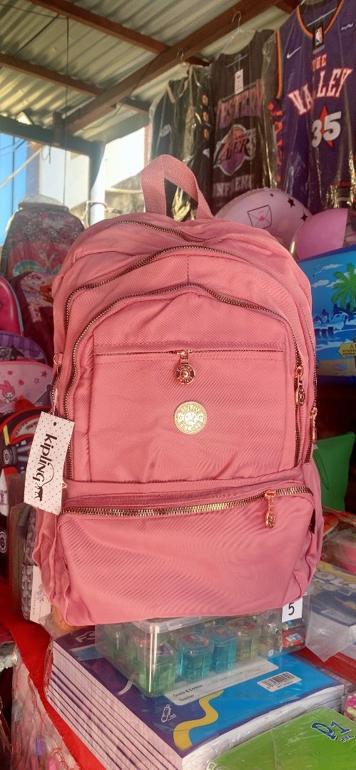 Kipling Pink Backpack with Rose Gold Accents and Monkey Charm (Category: Backpacks) located in Bulacan. Submitted by noblestorm.b17b1b (Listing ID 1440575311, Image 2). Description: - Adorable pink backpack - Stylish rose gold zippers and hardware - Includes a cute monkey charm keychain - Practical design with a front pocket and main compartment - Comfortable padded shoulder straps - Perfect for school or daily adventures - Brand new with tag sti