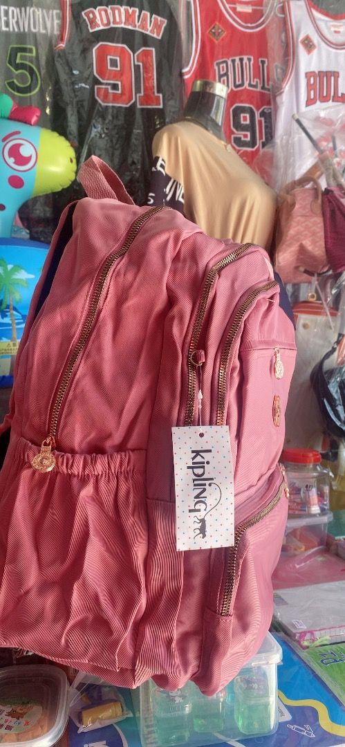 Kipling Pink Backpack with Rose Gold Accents and Monkey Charm (Category: Backpacks) located in Bulacan. Submitted by noblestorm.b17b1b (Listing ID 1440575311, Image 3). Description: - Adorable pink backpack - Stylish rose gold zippers and hardware - Includes a cute monkey charm keychain - Practical design with a front pocket and main compartment - Comfortable padded shoulder straps - Perfect for school or daily adventures - Brand new with tag sti