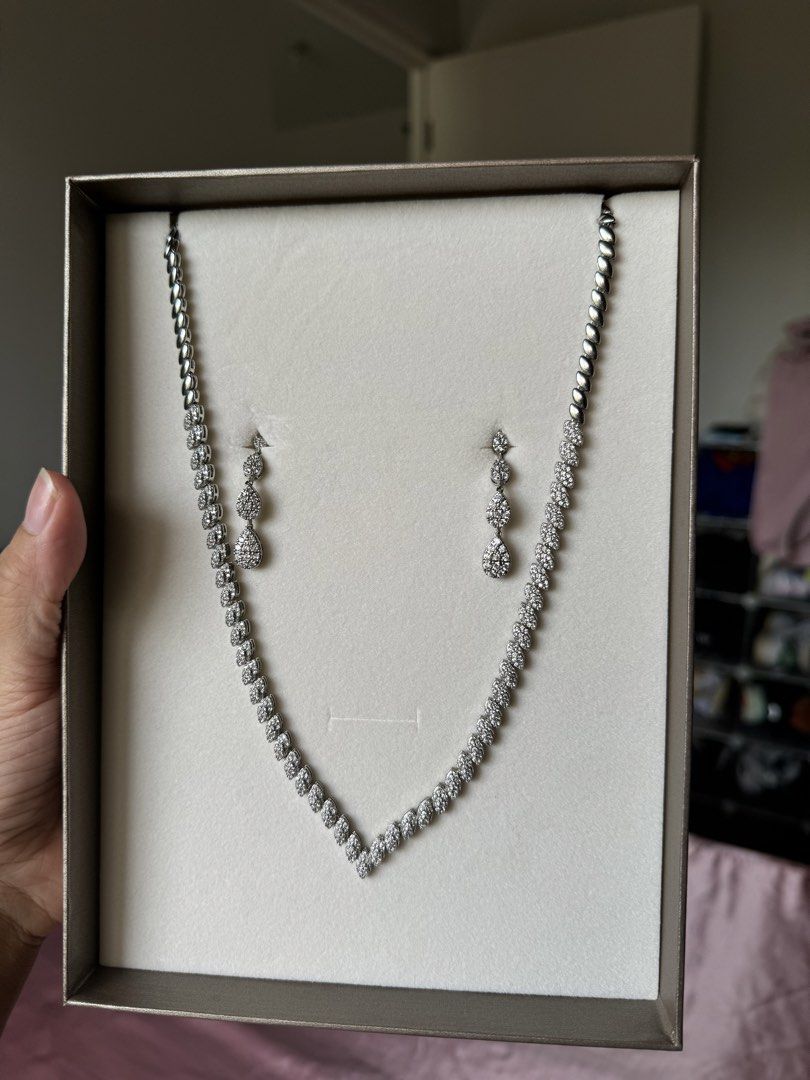 KLAD Necklace and Earrings Set (Category: Necklaces) located in Paranaque City. Submitted by roomcleanupph (Listing ID 1440432882, Image 1). Description: - Retail price was ₱7,298 - Worn once during wedding - Beautiful necklace and earrings set from KLAD - Features a V-shaped necklace with sparkling crystals - Includes matching drop earrings - Comes in its original box - Perfect for special occasions or as a gift.