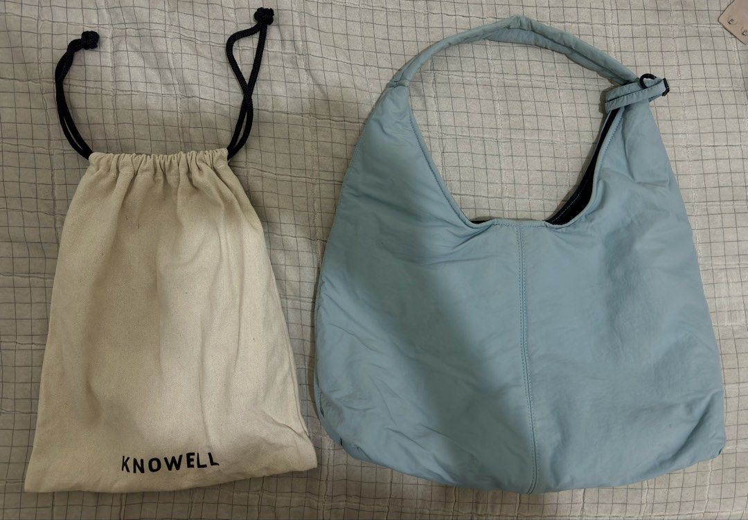 KNOWELL Shoulder Hobo Bag with Dust Bag (Category: Shoulder Bags) located in Candelaria. Submitted by preloveeedforless (Listing ID 1440519131, Image 1). Description: - Light blue padded shoulder bag from KNOWELL - Comes with original dust bag - Snap button closure inside - Adjustable strap hardware - Spacious interior - Ideal for everyday use Sells 1199 in Orange app, see attached photo for proof.