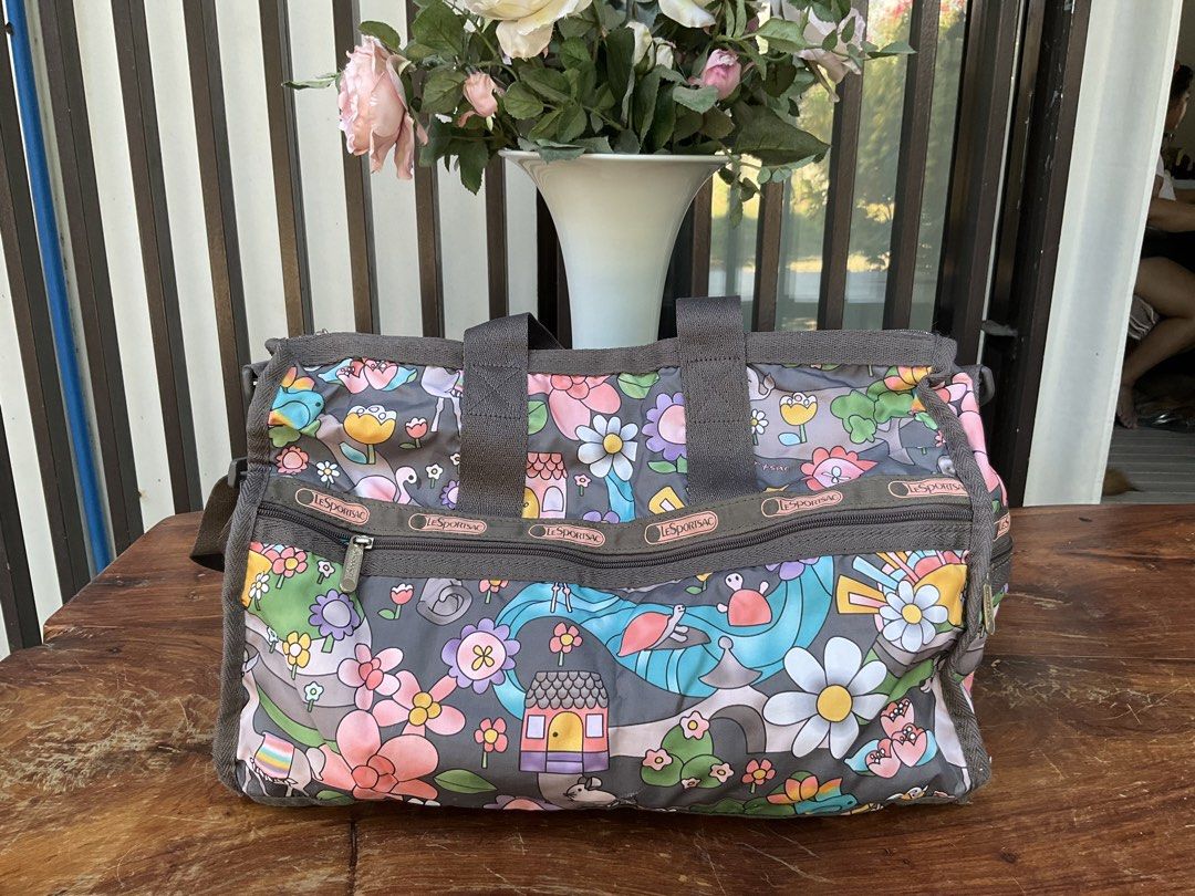 LeSportsac Weekender Bag - Fun Floral Print (Category: Cross-body Bags) located in Makati City. Submitted by ehloysah (Listing ID 1440537372, Image 2). Description: - Cute LeSportsac weekender bag - Fun, colorful floral and whimsical print - Gray handles and trim - Smooth working zippers - Plenty of interior space - Perfect for travel or everyday use.