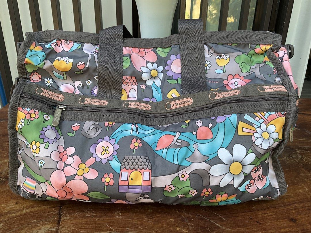 LeSportsac Weekender Bag - Fun Floral Print (Category: Cross-body Bags) located in Makati City. Submitted by ehloysah (Listing ID 1440537372, Image 3). Description: - Cute LeSportsac weekender bag - Fun, colorful floral and whimsical print - Gray handles and trim - Smooth working zippers - Plenty of interior space - Perfect for travel or everyday use.