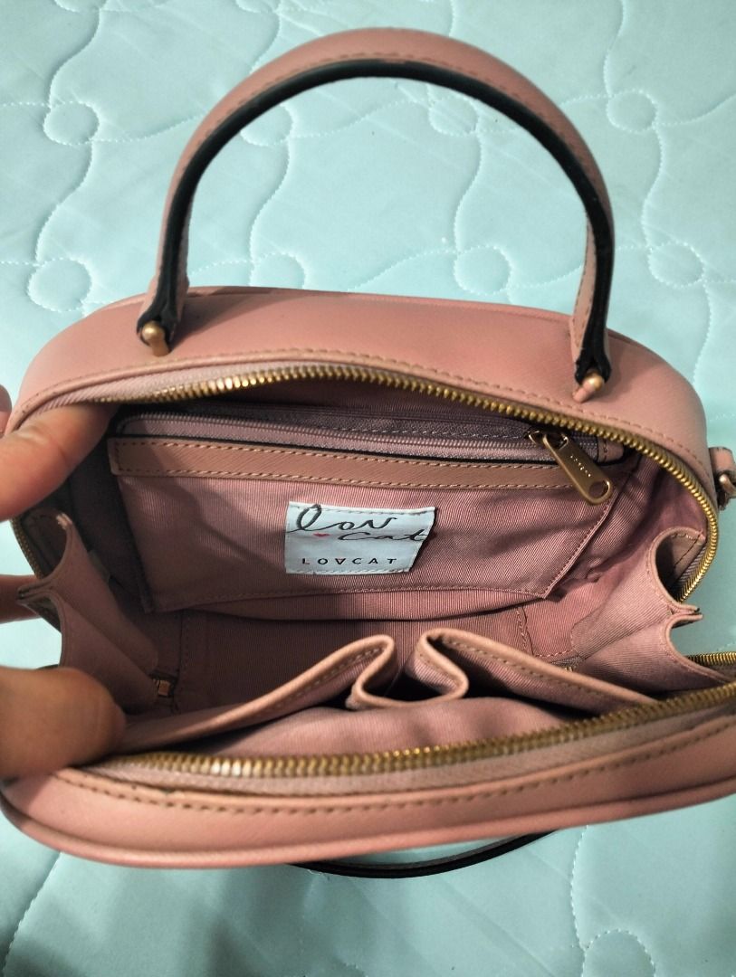 Lovcat Pink Structured Handbag with Chain Strap (Category: Luxury Bags & Wallets) located in Batangas. Submitted by selahs-closet (Listing ID 1440552402, Image 3). Description: - Lovcat structured handbag in pink - Features top handles and a detachable chain strap - Gold hardware details - Interior includes multiple compartments and a zip pocket - Clean inside and out - Versatile for everyday or special occasions.