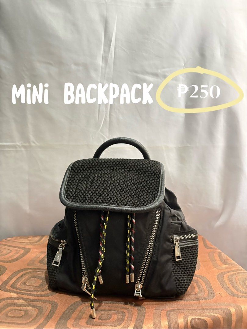 Mini Backpack (Category: Backpacks) located in Manila. Submitted by prieloved9 (Listing ID 1440449192, Image 1). Description: Black mini backpack. Has a mesh top flap and zippered pockets. Drawstring closure with colorful cords. Small top handle. Great for carrying essentials..