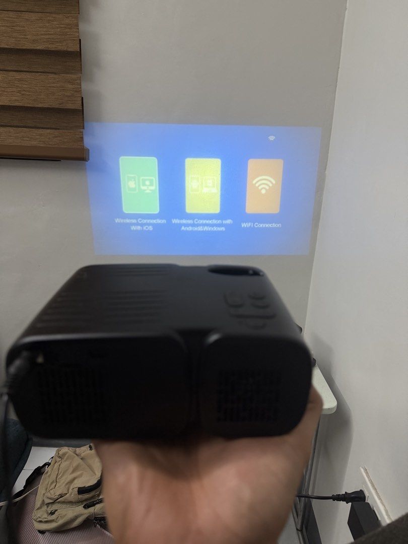 Mini Projector (Category: Soundbars, Speakers & Amplifiers) located in Bulacan. Submitted by mysticdeer.6d7f47 (Listing ID 1440547006, Image 3). Description: This is a Jimveo C11 or E11 mini portable projector.Resolution: It supports a Full HD 1080P resolution for clear viewing.Connectivity: The projector features WiFi capability and Bluetooth for wireless streaming from smartphones.Portability: It is designed as a compact, “ultra-small” unit sui