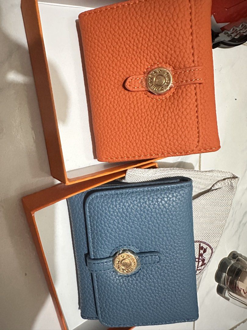 Orange and Blue Leather Wallets with Gold Clasp (Category: Wallets & Card holders) located in Paranaque City. Submitted by leannebont35668 (Listing ID 1440508038, Image 1). Description: - Set of 2 small wallets: 1 orange, 1 blue - Material: Pebbled leather texture - Closure: Gold-tone clasp - Includes: Original boxes and dust bags - Ideal for: Organizing cards and cash.
