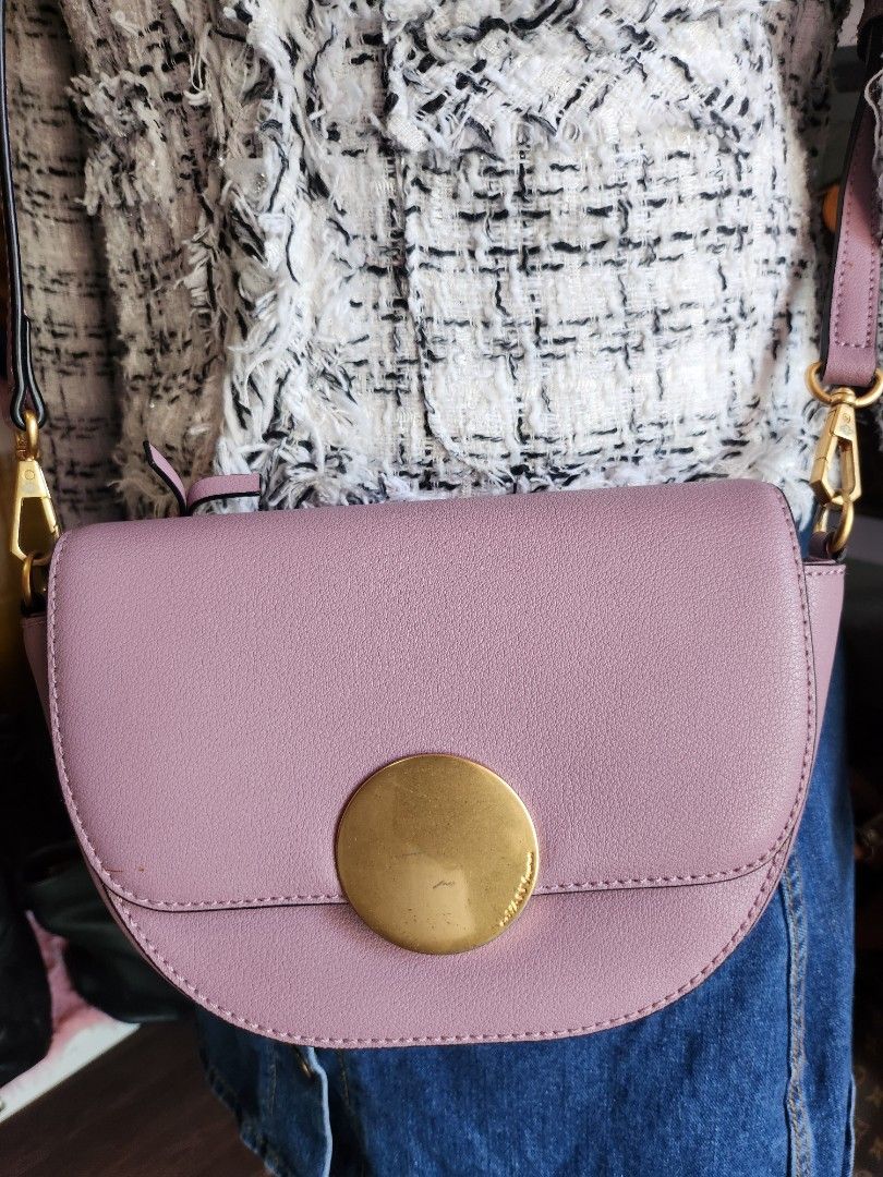 Oryany Lottie Saddle Crossbody Small Handbag. (Category: Cross-body Bags) located in Caloocan City. Submitted by xcessbaggs (Listing ID 1440539216, Image 2). Description: New Arrival!!! In good preloved condition from Korea. Design Features:Half-circle saddlebag silhouetteSignature large gold-tone round disk closure -Removable and adjustable leather crossbody strap -Magnetic button snap closure under the flap -Back exterior zipper pocket and inte