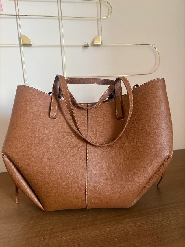 Polene Cyme Camel from GaryZ Bags (Category: Tote Bags) located in Lucena. Submitted by mademoisellemd (Listing ID 1440402804, Image 1). Description: Polene Cyme Large in Camel Genuine Leather Bought from Gary Z Bags sa TikTok shop. Bought for 4k+ Selling lang for 2800 Rfs di nagagamit Only flaw is yung peeling sa magnet area.
