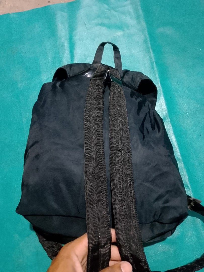 Prada Nylon Backpack (Category: Luxury Bags & Wallets) located in Iloilo. Submitted by janillthrifted (Listing ID 1440535271, Image 3). Description: - Prada backpack - Classic black color - Durable nylon material - Multiple interior and exterior pockets - Secure buckle closure - Adjustable straps for comfortable wear - Ideal for everyday use, school, or travel.