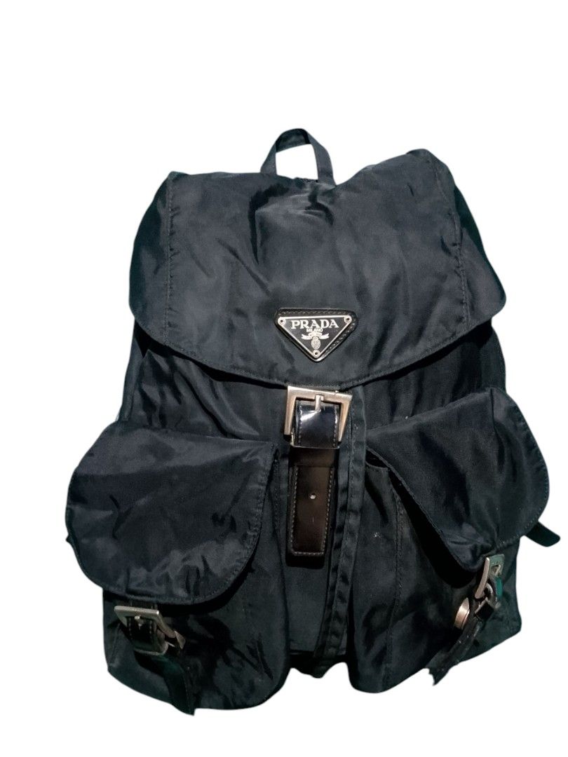 Prada Nylon Backpack (Category: Luxury Bags & Wallets) located in Iloilo. Submitted by janillthrifted (Listing ID 1440535271, Image 1). Description: - Prada backpack - Classic black color - Durable nylon material - Multiple interior and exterior pockets - Secure buckle closure - Adjustable straps for comfortable wear - Ideal for everyday use, school, or travel.