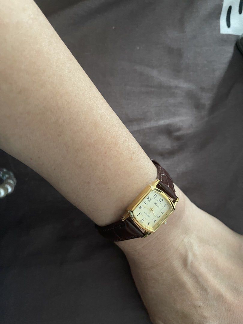 Q&Q Rectangular Gold Tone Watch Brown Leather Strap Water Resist (Category: Women's Watches) located in Caloocan City. Submitted by veryred (Listing ID 1440463788, Image 1). Description: - Gold tone rectangular watch - Cream dial with Arabic numerals - Brown leather strap - Water resistant - Assembled in China - Made with base metal and stainless steel back - Ideal for everyday wear.