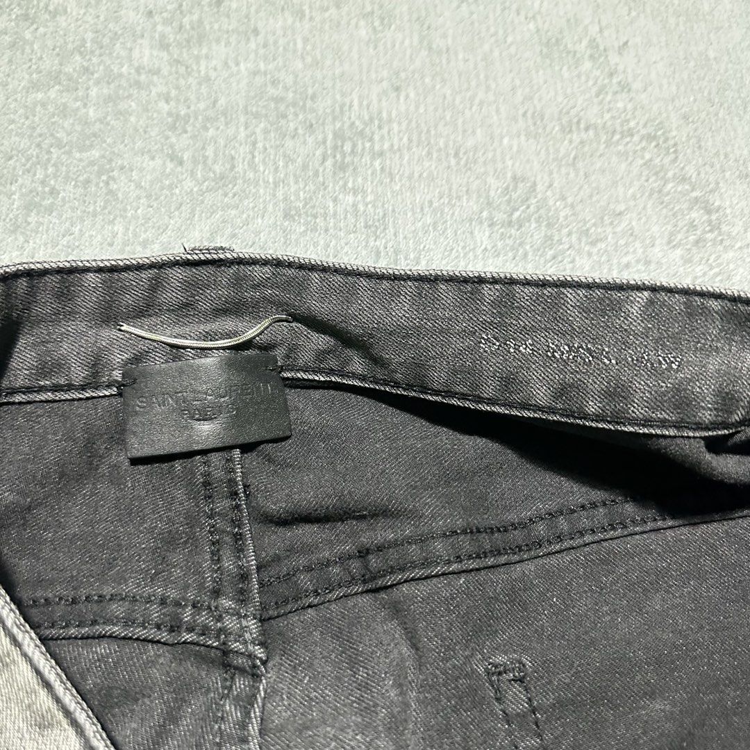 Saint Laurent Grey Washed Denim Jeans (Category: Jeans) located in Villaverde. Submitted by bakatzy_secondhand_garments (Listing ID 1440391415, Image 3). Description: - Brand: Saint Laurent - Color: Grey Washed Denim - Style: Classic Five-Pocket - Closure: Button and Zip Fly - Fit: Straight Leg - Ideal for: Everyday Wear - Note: Please check measurements for exact fit.
