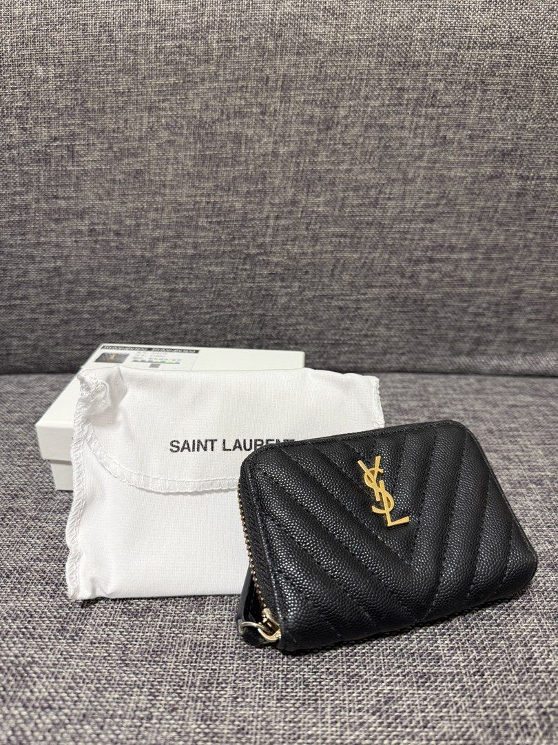 Black Wallet/ small wallet (Category: Luxury Bags & Wallets) located in Manila. Submitted by hannabananahhh (Listing ID 1440438834, Image 1). Description: Saint Laurent coin purse - Black pebbled leather with chevron quilting - Signature gold YSL logo on the front - Secure zipper closure - Interior features multiple card slots - Comes with original dust bag and box - Ideal for keeping your essentials neatly organized.