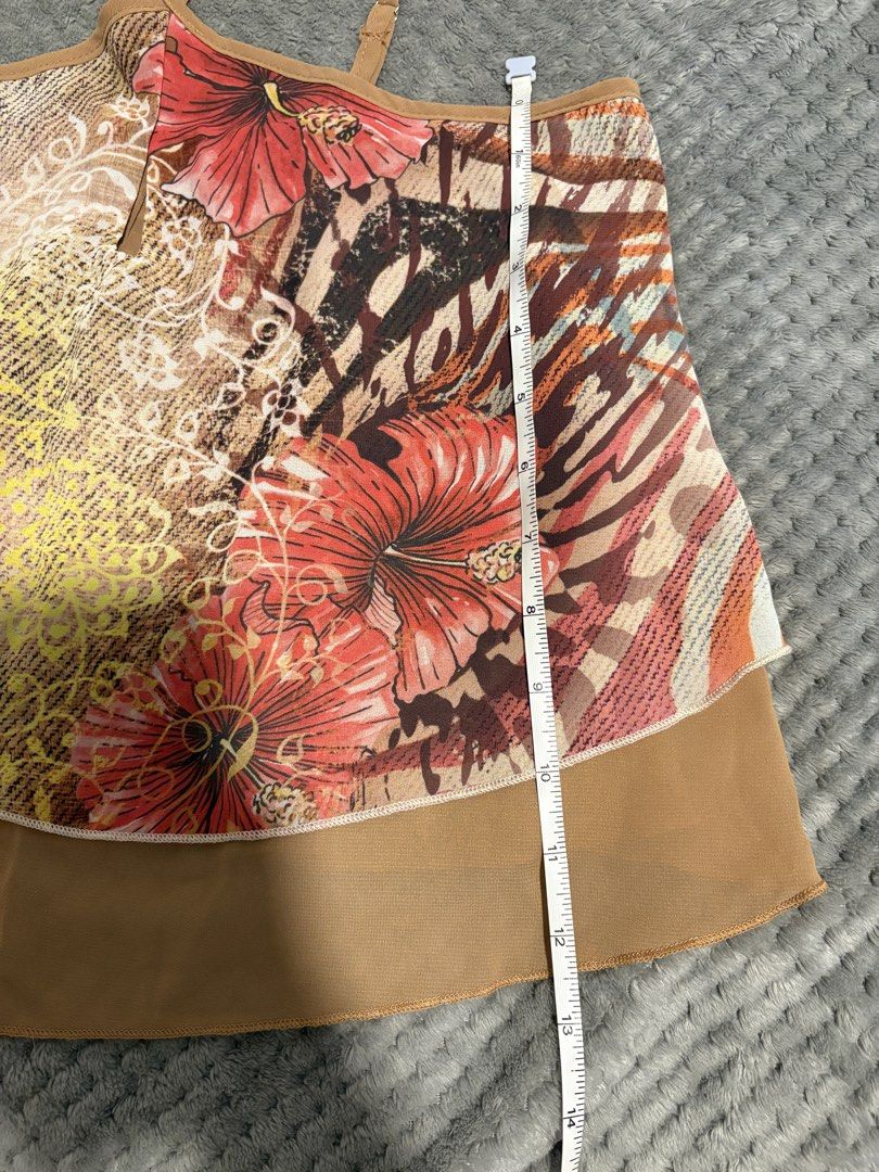 Layered Tropical Floral Print Halter Top (Category: Sleeveless) located in Manila. Submitted by icy_________ (Listing ID 1440394380, Image 3). Description: - Light and airy layered tank top - Vibrant tropical print with hibiscus and animal accents - Tan chiffon overlay at the hem - Adjustable spaghetti straps - Ideal for beach vacations or casual summer days.