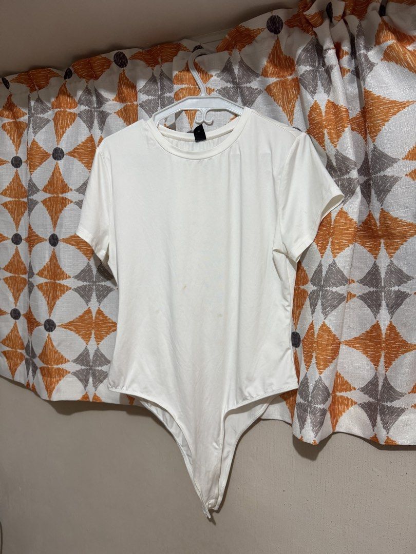 SHEIN White Short Sleeve Bodysuit (Category: Others Tops) located in Manila. Submitted by mxbeex (Listing ID 1440517820, Image 1). Description: - White short sleeve bodysuit - Size 1XL - Ideal for layering or wearing as a standalone piece.