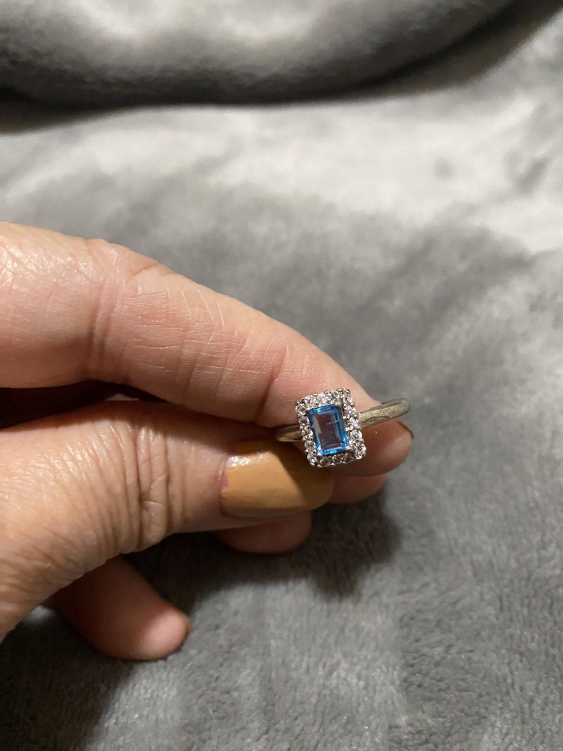 Silver Ring with Blue Stone and White Accents (Category: Rings) located in Manila. Submitted by robinhood123_134 (Listing ID 1440510791, Image 1). Description: - Elegant silver-toned ring - Features a striking rectangular blue stone - Accented with sparkling small white stones - Estimated size 6 or 7 - Versatile for everyday wear or special events - Feel free to ask any questions!.