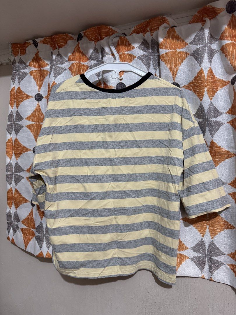 Striped 3/4 Sleeve T-shirt (Category: Tshirts & Polo Shirts ) located in Manila. Submitted by mxbeex (Listing ID 1440518546, Image 2). Description: - Casual yellow and grey striped t-shirt - Features three-quarter length sleeves - Black trim detailing around the neckline - Designed for comfort and everyday wear - Effortlessly pairs with jeans or shorts.