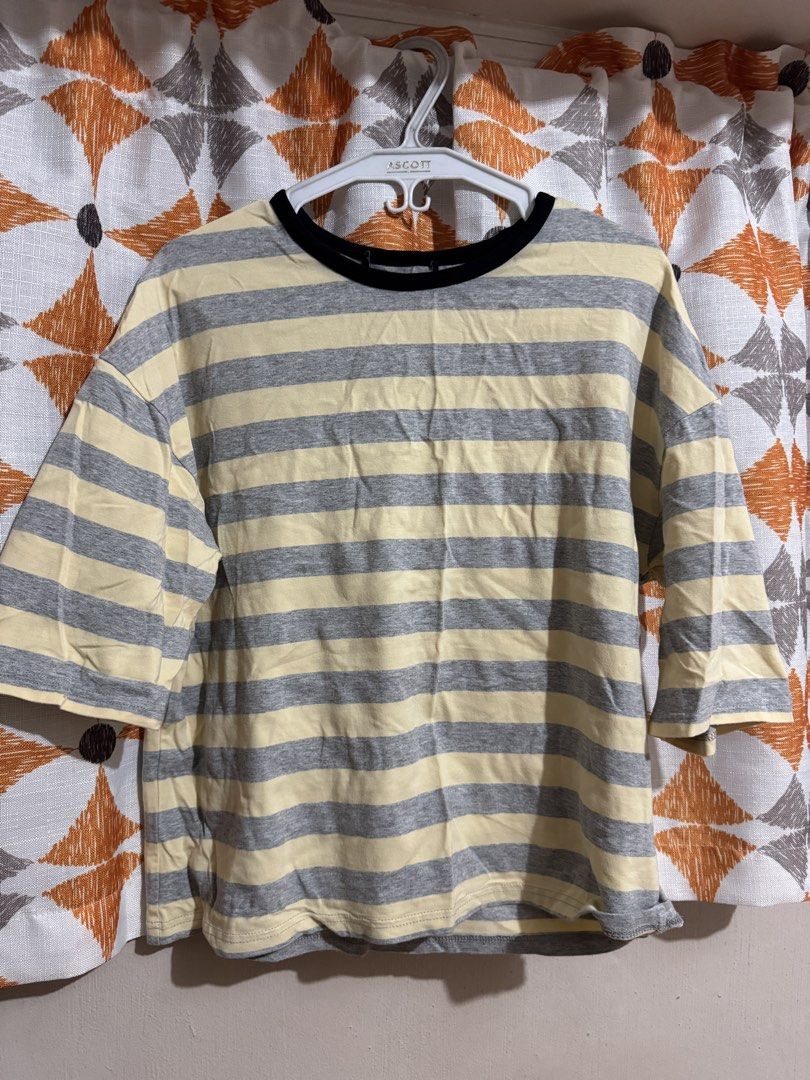 Striped 3/4 Sleeve T-shirt (Category: Tshirts & Polo Shirts ) located in Manila. Submitted by mxbeex (Listing ID 1440518546, Image 1). Description: - Casual yellow and grey striped t-shirt - Features three-quarter length sleeves - Black trim detailing around the neckline - Designed for comfort and everyday wear - Effortlessly pairs with jeans or shorts.