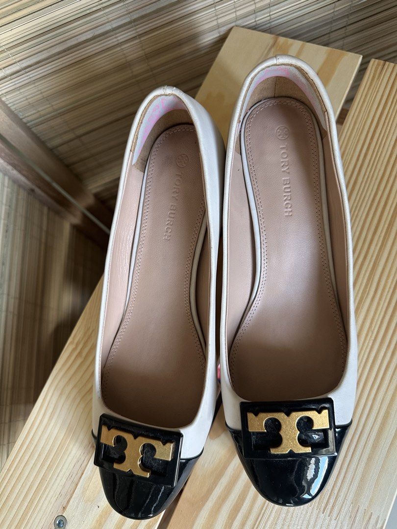 Tory Burch GiGi round toe heel pumps (Category: Flats & Sandals) located in Mandaluyong City. Submitted by rustic_swirls (Listing ID 1440497184, Image 2). Description: - Tory Burch GiGi round toe heel pumps - White with black patent cap toe - Iconic gold Tory Burch logo hardware - Soles show some wear from use - Great for dressing up.