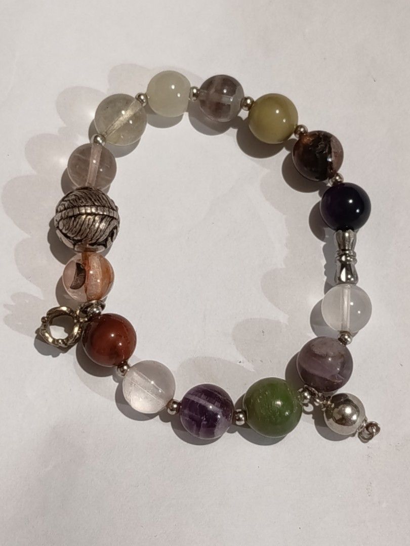 Unique Quartz Bracelet with Charms/Accents (Category: Bracelets) located in Famy. Submitted by potato.label (Listing ID 1440395520, Image 2). Description: - Unique bracelet with a mix quartz stone beads - Features different charms with intricate designs - Elastic band for comfortable and easy wear. - Perfect accessory to elevate your style..