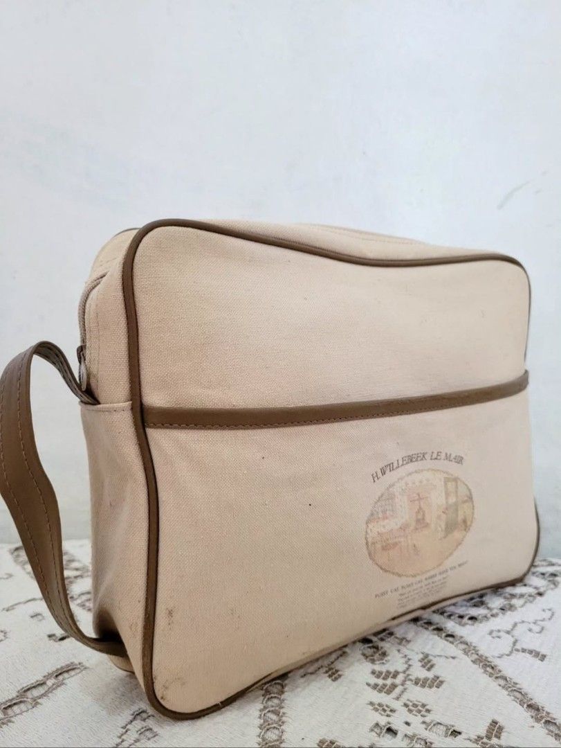 Vintage Canvas Leather Hand Bag (Category: Purses & Pouches) located in Balanga. Submitted by marae_c (Listing ID 1440518275, Image 2). Description: In very good condition. With minimal flaws, may onting dumi sa may ilalim and small sa likod, see last pics for ref. other than that all goods and a good quality bag. Rfs. Decluttwring from my personal collection. Not in use. Have too many bags already. Sa mga nakakakila and nagccollect ng book artpi