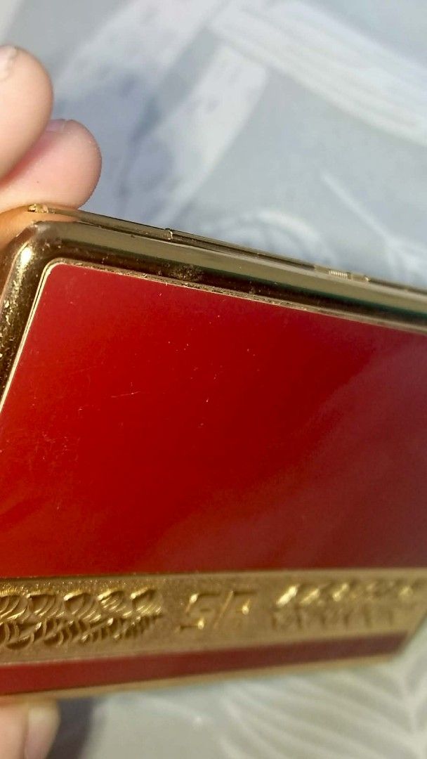 Vintage SR Gold and Red Cigarette Case Holder (Category: Vintage Collectibles) located in Los Banos. Submitted by tritrollse.04 (Listing ID 1440444161, Image 2). Description: - Elegant gold and red cigarette case. - Features a decorative border with 'SR' initials. - Opens to a shiny gold interior. - Includes a strap to keep cigarettes in place. - Secure clasp for safe closure. - A timeless accessory for your cigarettes. -very visible signs of usa