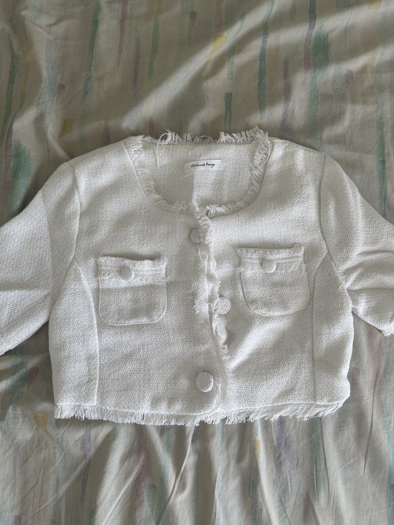 White Cropped Tweed Jacket with Fringed Trim (Category: Coats, Jackets and Outerwear) located in Paranaque City. Submitted by declutterwyae (Listing ID 1440437482, Image 3). Description: - White cropped jacket - Textured tweed fabric - Short sleeves with fringed cuffs - Fringed hemline and neckline - Button-up front with two chest pockets - Estimated size: Small - Perfect for dressing up or down.