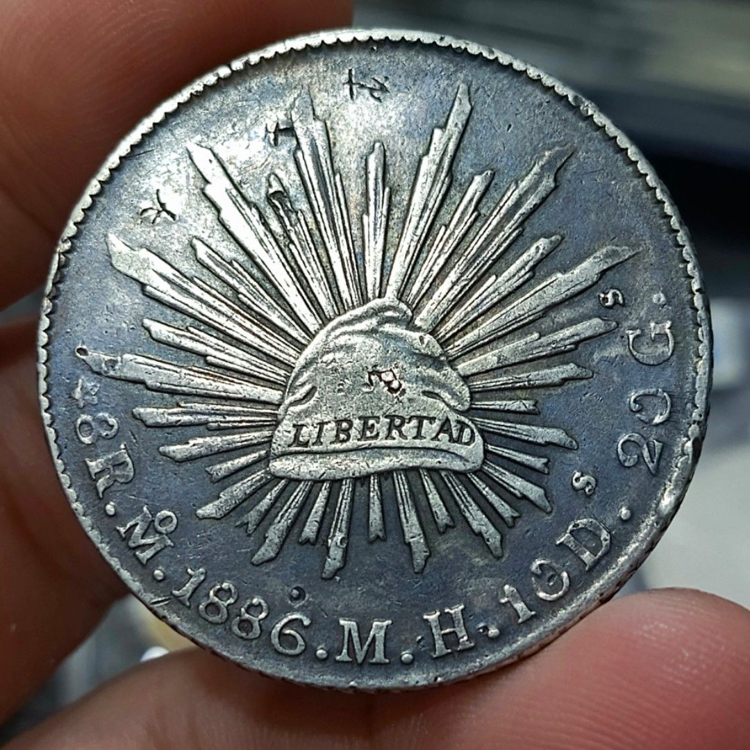 1886 Mexican Silver Peso Coin (Category: Currency) located in Quezon City. Submitted by Coiners (Listing ID 1440595055, Image 1). Description: - Authentic 1886 Mexican Silver Peso coin - Features the Mexican coat of arms - Displays the radiant Liberty cap - Ideal for coin collectors.