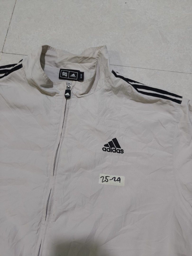 Adidas Vintage Windbreaker Jacket with 3 Stripes (Category: Coats, Jackets and Outerwear) located in Manila. Submitted by jamtnf (Listing ID 1440753039, Image 3). Description: - Classic Adidas Vintage jacket - Iconic 3 stripes on shoulders - Zip-up front with stand-up collar - Adjustable drawstring hem - Perfect for casual wear or sports - Issue small pinhole on sleeve (see 2nd picture).