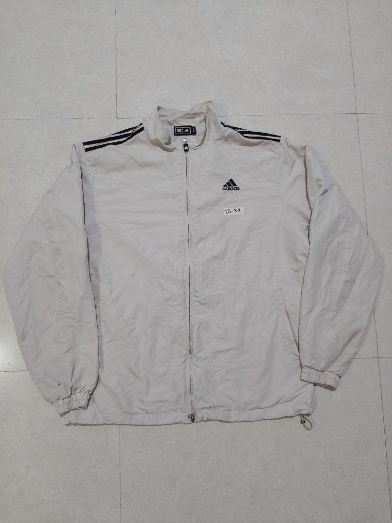 Adidas Vintage Windbreaker Jacket with 3 Stripes (Category: Coats, Jackets and Outerwear) located in Manila. Submitted by jamtnf (Listing ID 1440753039, Image 1). Description: - Classic Adidas Vintage jacket - Iconic 3 stripes on shoulders - Zip-up front with stand-up collar - Adjustable drawstring hem - Perfect for casual wear or sports - Issue small pinhole on sleeve (see 2nd picture).